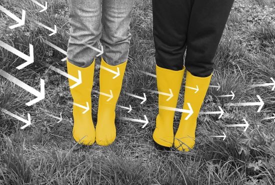 Two pairs of yellow wellies with white arrows zooming from left to right over the top of them.