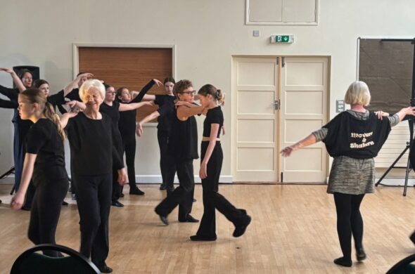 Young and old female dancers circle a room