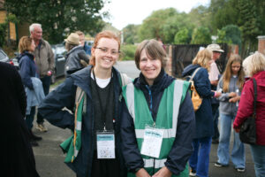 An older woman with short grey hair and a younger woman with tied back ginger hair pose for a photo.